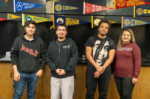 Four Transfer Students standing against a black wall