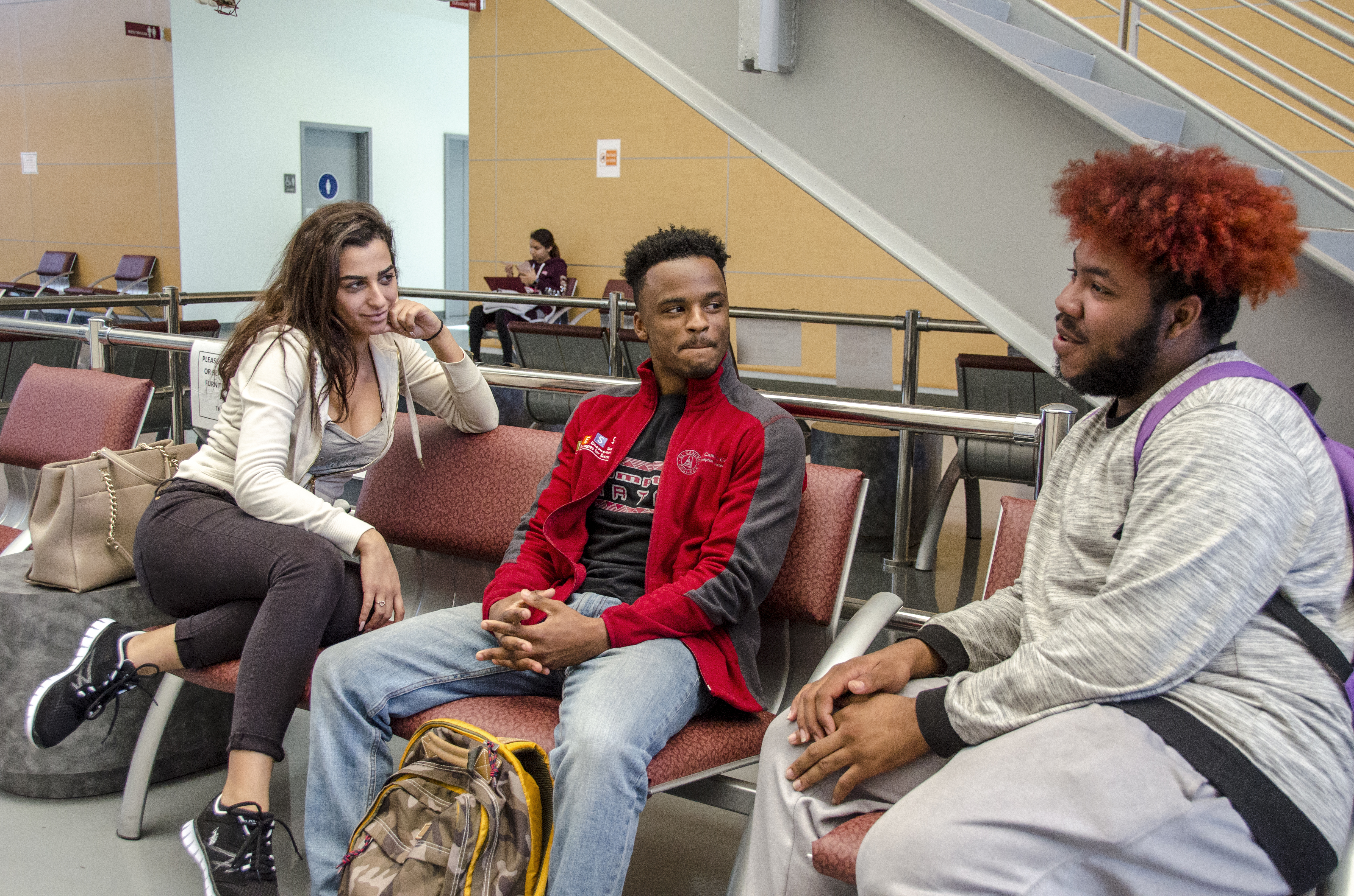 three college students sitting 