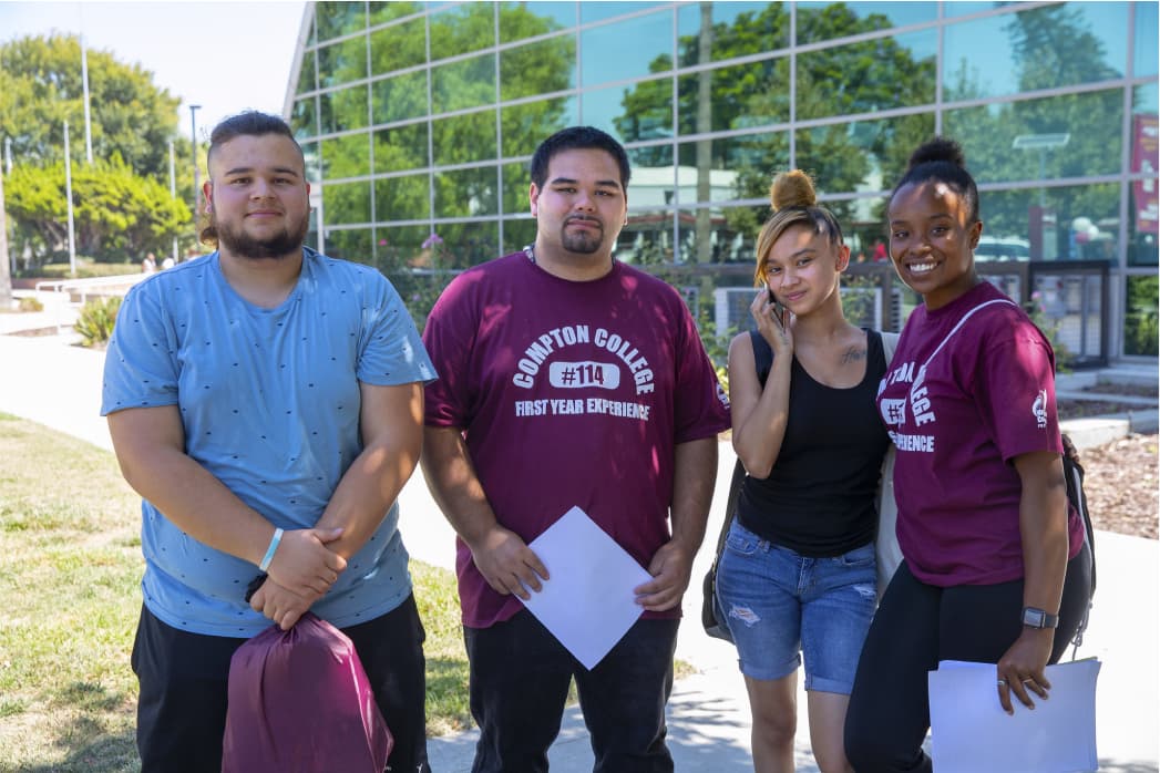 Four students similing at camera