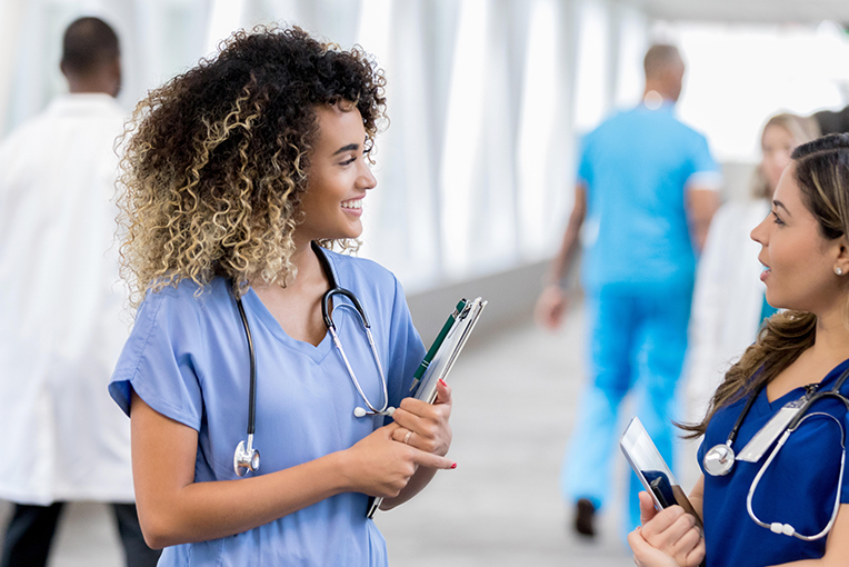 Two nursing graduates smiling