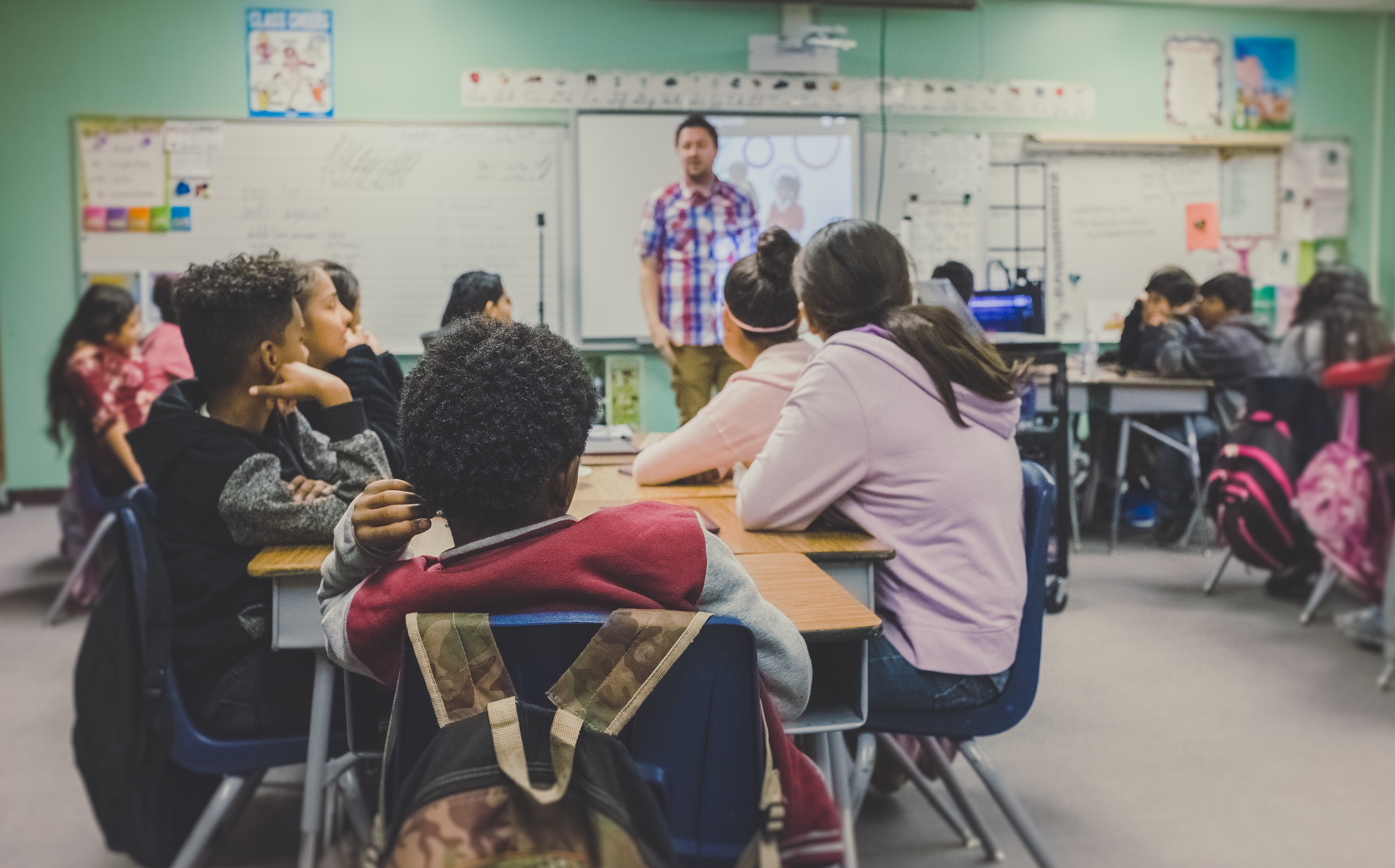 Teacher standing in front of classroom of children