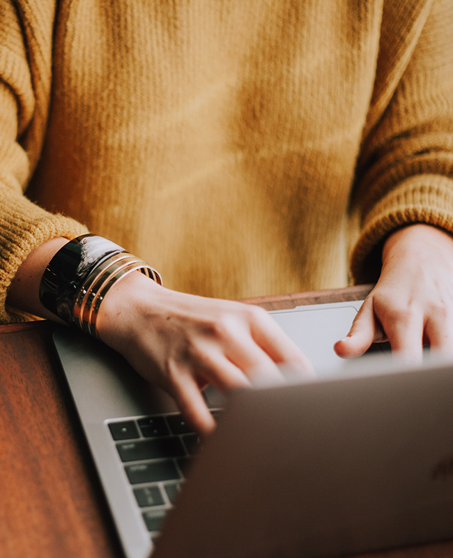 Close up of woman typing on laptop