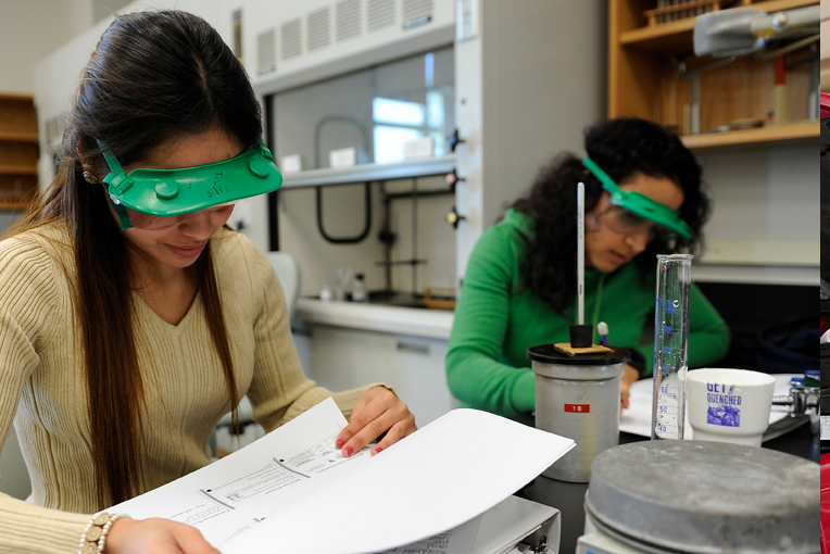 two female students studying a manual