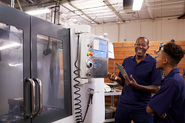 View Program Machine Tool Technology Two men working on manufacturing equipment 