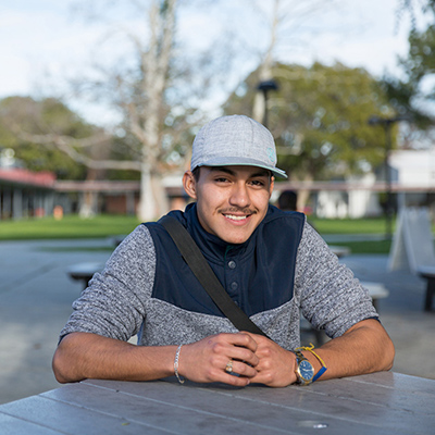 Image of a young man sitting at a table